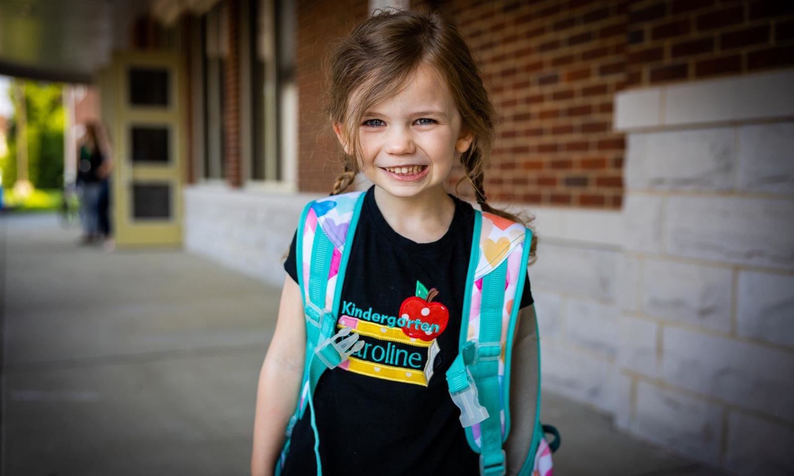 kindergarten student smiles
